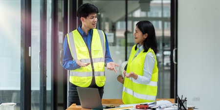 Civil engineers and architects discuss project construction together at officeの写真素材