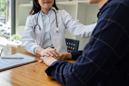 young woman Asian doctor patient, patting shoulder with care, support, sympathy, hope, giving comfort, empathy, asking about health patientの写真素材