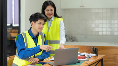 Civil engineers and architects discuss project construction together on laptop at the office and...