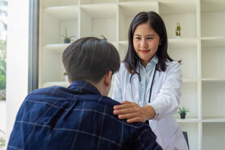 young woman Asian doctor patient, patting shoulder with care, support, sympathy, hope, giving comfort, empathy, asking about health patientの写真素材