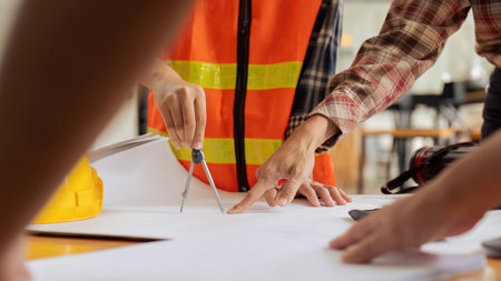 Construction and structure of Engineer or architect meeting for project working with partner and tools on model building and blueprint in working siteの写真素材