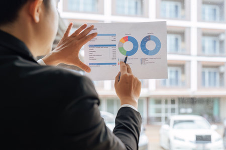 young business woman showing documents with graphs. Presents the steady growth of the companys...