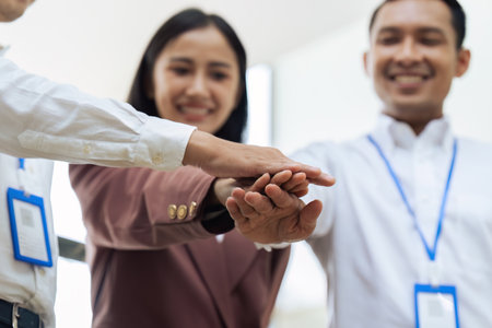 Closeup hand of Businesspeople unity between business people with their hands stacked for project...