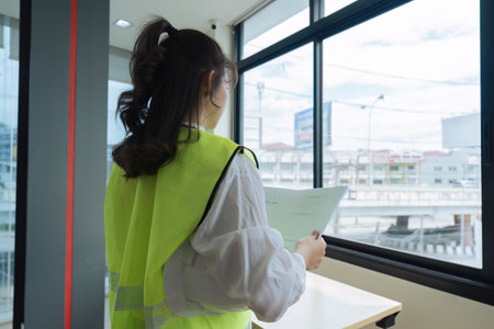 Building construction management with an architect and engineering blueprintの写真素材