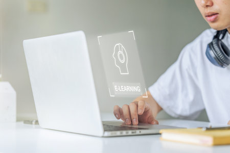 young man using laptop for learning course online, searching informationの写真素材