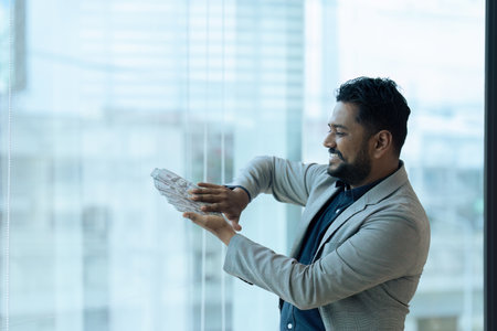 Business man happy scattering money after success investment with partnerの写真素材