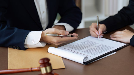 Close up of businessman or lawyers discussing about signing his signature on contractの写真素材