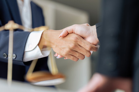 Businessman shaking hands to seal a deal with his partner lawyers or attorneys discussing a contract agreementの写真素材