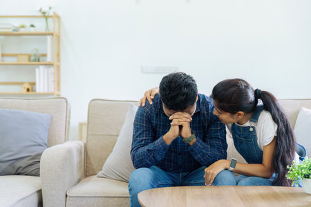 Compassionate wife giving comfort and support to husband who is worried about work