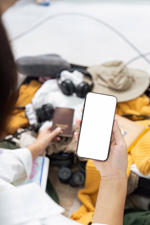 Mockup mobile phone with white screen, luggage in backgroundの写真素材