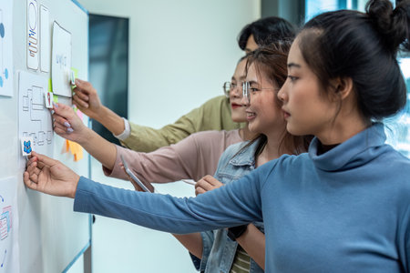 Team of ux developer and ui designer brainstorming interface wireframe design. Creative digital development agencyの写真素材