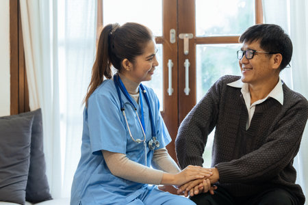 Happy nurse caring for an elderly man and support him to walk with a walkerの写真素材