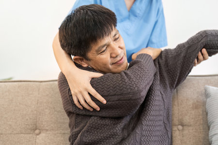 Asian female doctor advice elderly patient to physiotherapist to exercise at homeの写真素材