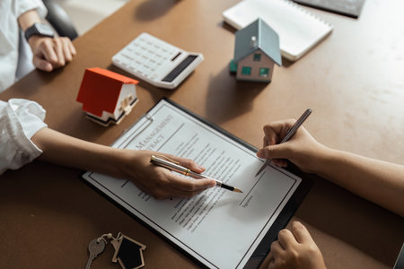 Real Estate Agent explain Property insurance and security concept about house to client before sign contractの写真素材