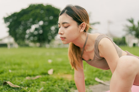 Asian woman wearing sportwear doing Yoga exercise in the natureの写真素材