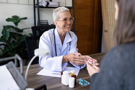 Senior female doctor are advise medication and vitamin daily to patientの写真素材