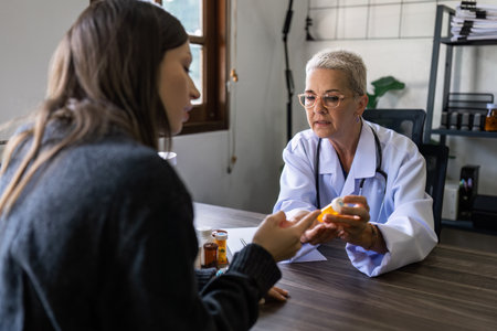 Senior female doctor are advise medication and vitamin daily to patientの写真素材