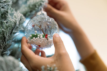 Young Asian woman decorate for Christmas at home. Family celebrate and Happy new year at homeの写真素材