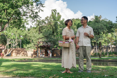 elderly married couple retired have a picnic together in the park. senior retired conceptualの写真素材