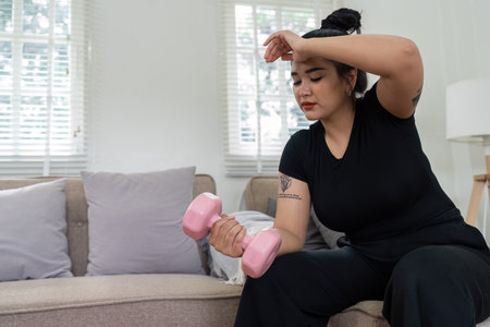 Cheerful attractive young overweight woman in activewear choosing healthy lifestyleの写真素材