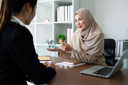 Real Estate Agent and client talking about Property insurance and security concept about house to client before sign contractの写真素材