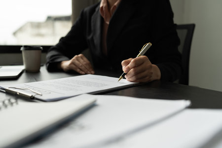 Signing contract, Closeup businessman signing business contract document. business agreement and deal conceptの写真素材