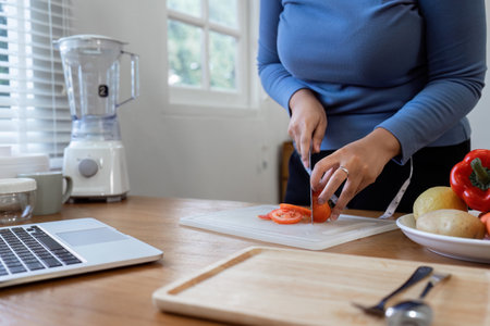 Women stay at home to prepare healthy meals, carrying trays of vegetables to prepare healthy salads at homeの写真素材
