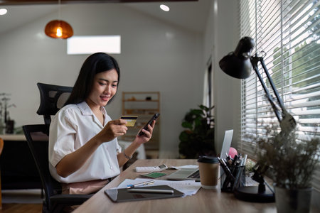 female using mobile telephone to make easy safe payment online in electronic bank system. Young lady...