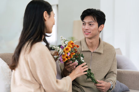 Young couple Hug and giving flower on Valentines Day. Romantic day together. Valentines Day conceptの写真素材