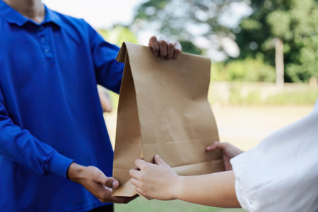 service shopping online asian young woman, girl hand received order, delivery man carrying paper bag...
