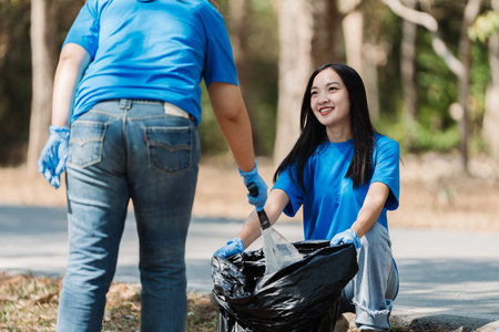 Group of volunteers, community members cleaning the nature from garbage and plastic waste to send it...