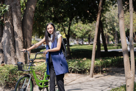 Professional Business woman with bike in the morning walking in the street to work. Eco friendly