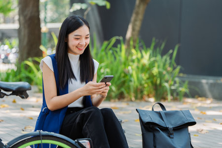 asian young businesswoman use smart phone while commuting in city. Eco friendlyの写真素材