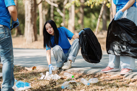 Group of volunteers, community members cleaning the nature from garbage and plastic waste to send it...