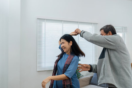 Happy cheerful middle aged mature couple family parent dancing together in the living room