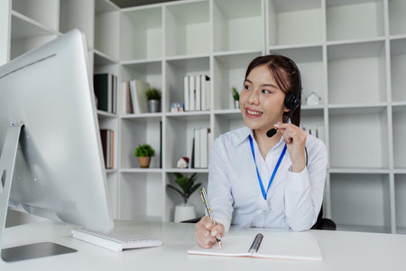 Customer service, woman and happy call center agent giving advice online using a headsetの写真素材