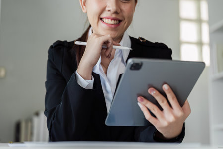Accountant business woman working with tablet to think strategy and analyzeの写真素材