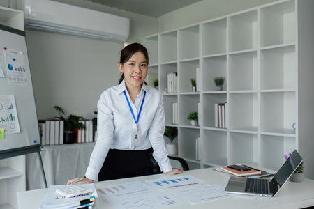 successful businesswoman standing and looking confident at cameraの写真素材
