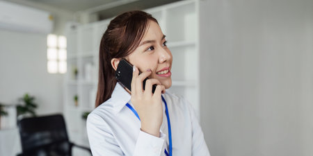 Business woman talking on mobile with client, business partner for business meetingの写真素材
