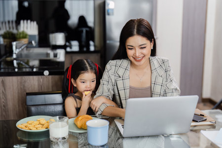 business woman work from home and take care of her child while workingの写真素材