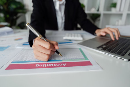 Accountant working on financial data analysis dashboard on paper as marketing indication for business strategic planningの写真素材