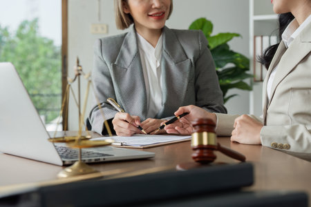 Lawyer advise client on business matter and advise them to sign documentの写真素材
