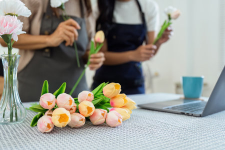 Mother and daughter arrange flower together at home on the weekend, family activities, mother and daughter do activities together on Mothers Dayの写真素材