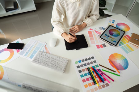 Graphic or UI designer work on computer laptop and with tablet after brainstorming unique design...