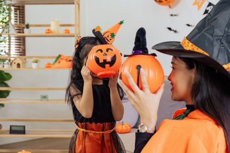 Mother and her daughter having fun at home. Happy Family preparing for Halloween