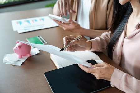 Couple Discussing Savings and Banking strategy with Documents and Piggy Bankの写真素材
