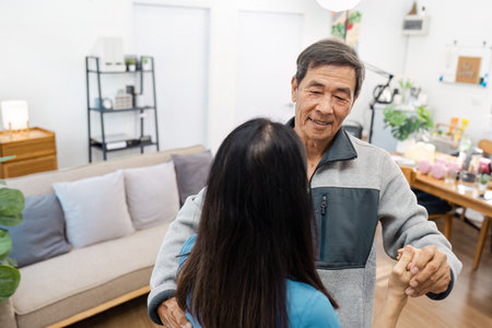 Elderly Couple Dancing in a Cozy Living Room with Modern Decor and Warm Lighting