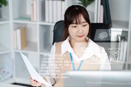 Young Professional Woman Analyzing Data on a Computer in a Modern Office Environment