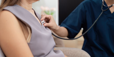 Medical Professional Using Stethoscope to Examine Patient During Routine Check-Up in Modern Clinic