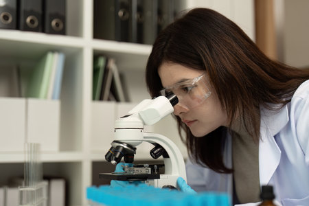 Scientist Using Microscope in Modern Laboratory for Research and Analysis